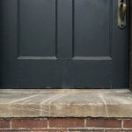 Old wooden door with visible gaps and weatherstripping in Columbus OH home