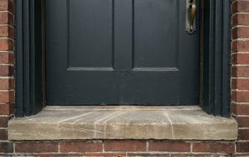 Old wooden door with visible gaps and weatherstripping in Columbus OH home