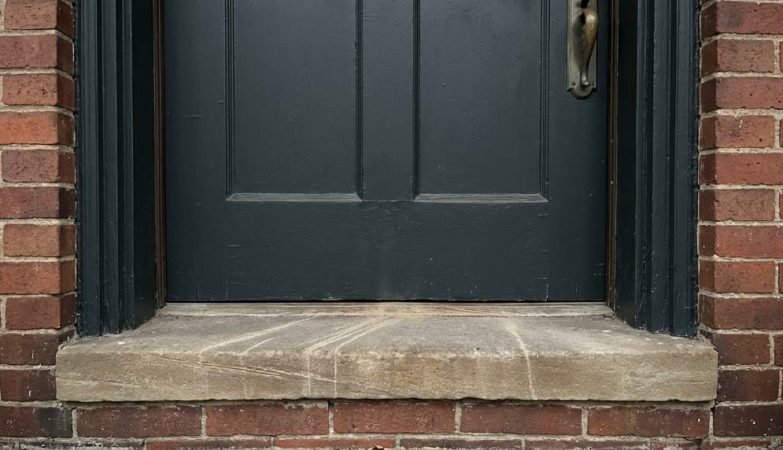 Old wooden door with visible gaps and weatherstripping in Columbus OH home