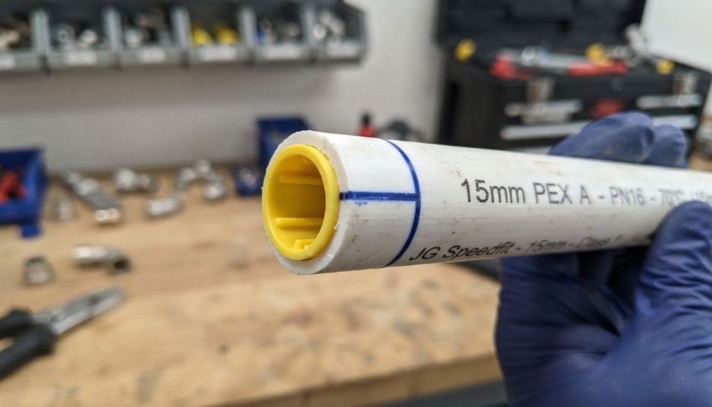 Installing a copper push-fit connector on plastic tubing